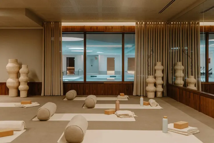 A warm-toned fitness studio set for a group class